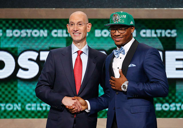 Oklahoma State's Marcus Smart, right, poses for a photo with NBA commissioner Adam Silver after being selected sixth overall by the Boston Celtics during the 2014 NBA draft.